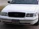2000 Ford Crown Victoria - Front view of a white 2000 Ford Crown Victoria, showing the grille and headlights.