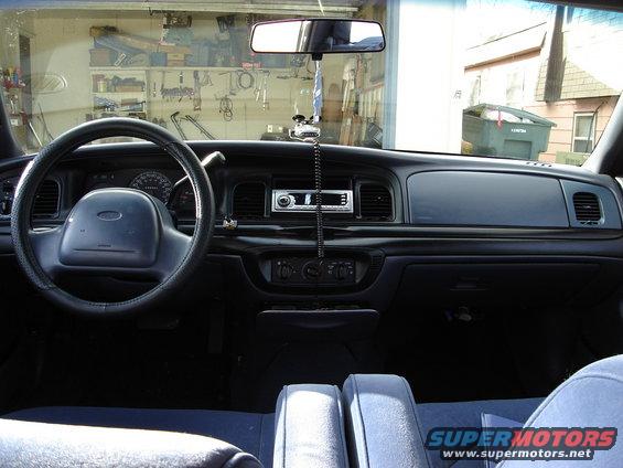 Interior of a 2000 Ford Crown Victoria, showing dashboard, steering wheel, and seats