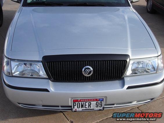 Silver Mercury Grand Marquis front grille with 'POWER 99' license plate