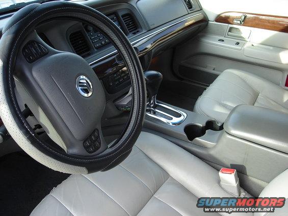 2000 Ford Crown Victoria interior showing steering wheel, dashboard, center console, and front seats