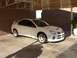 1996 Ford Probe - This white sedan, likely a Dodge Neon SRT-4, is shown from a three-quarter front angle under a covered patio.