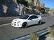 1996 Ford Probe - A white Dodge Neon SRT-4 drives on a winding road through a rocky, mountainous landscape.