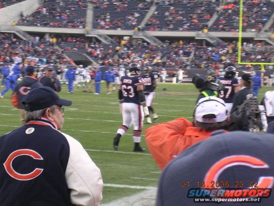 Football players on a field with spectators in the stands