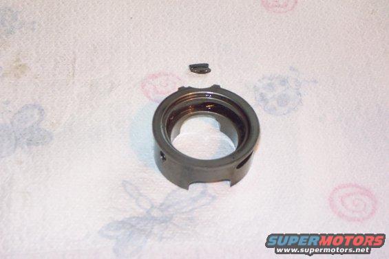 dcp_0874.jpg [b]PowerTrax No-Slip Locker[/b]

[b]Symptom:[/b] Frequently, most of the time, would not lock passenger side wheel, and noisy operation when it would.

[b]Cause:[/b] The synchro paddle on the Active Spacer broke off (top center) and the loose piece would get caught between the Driver and Coupler preventing them from engaging.

[b]In the Picture:[/b] Slotted Active Spacer and broken paddle (tab).

(1/7/2006)