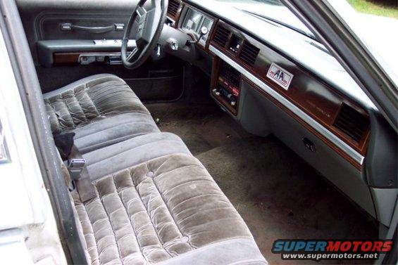 1988 Mercury Grand Marquis interior with velour seats, wood trim dashboard, and a license plate frame