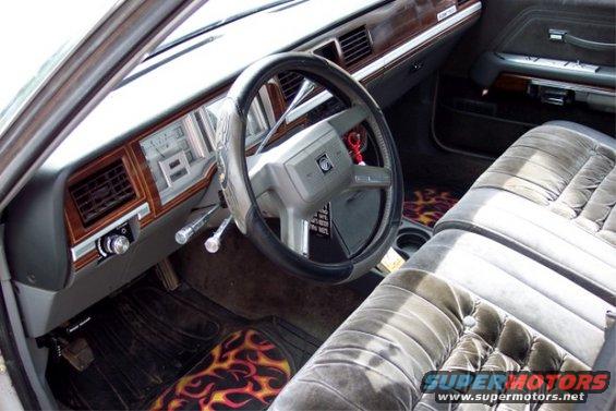 1988 Mercury Grand Marquis interior showing dashboard, steering wheel, and front seats with flame floor mats