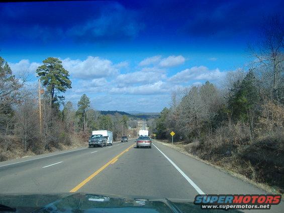 Truck towing a white trailer on a highway