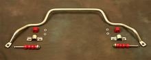 Sway bar with red bushings and mounting hardware on a brown surface