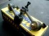 Two suspension stabilizer links resting on a yellow box
