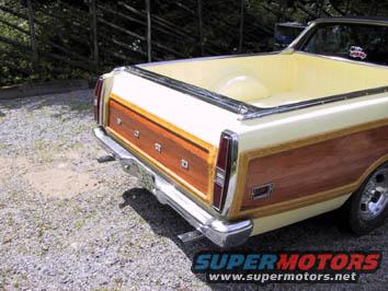 Rear view of a 1970 Ford Ranchero with wood paneling and a yellow bed