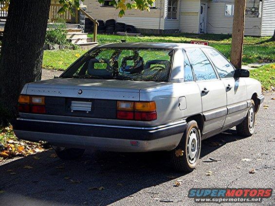 Silver 1985 Audi A6 sedan, rear 3/4 view, parked on street