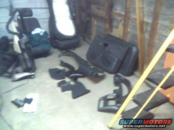 Car door panel and other disassembled interior parts on a concrete floor