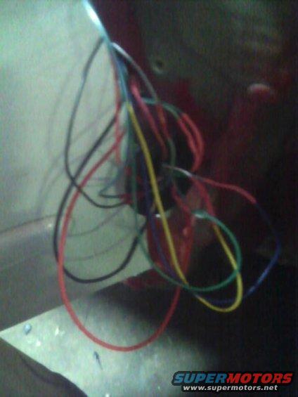 Bundle of red, blue, yellow, and green wires tangled together
