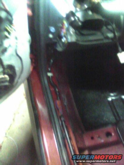 car interior with wires and red door panel visible