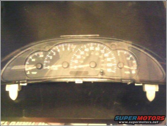 Dashboard instrument cluster with speedometer, tachometer, and fuel gauge