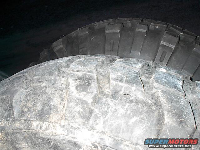 Close-up of a white textured surface, possibly snow or a tire