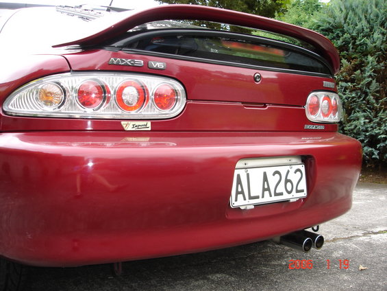 Red Mazda MX-3 V6 rear bumper with spoiler and dual exhaust pipes