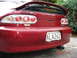 1993 Mazda MX-3 - The rear of a red Mazda MX-3 V6 shows its distinctive taillights and spoiler.