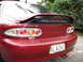 1993 Mazda MX-3 - Rear view of a red 1993 Mazda MX-3, its distinctive taillights and V6 badging.