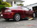 1993 Mazda MX-3 - 1993 Mazda MX-3 coupe is shown from a 3/4 front angle while elevated on ramps.