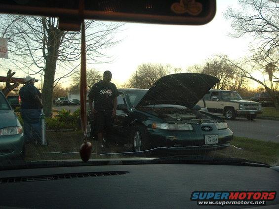 Dark sedan, hood open, with license plate LFN-08M. Appears to be a 1995 model