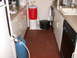 1995 Ford Bronco - A kitchen scene shows brewing equipment including a gas tank, cooler, and pots, set against tiled flooring and cabinetry.