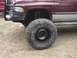 2001 Dodge 1500 - Front corner view of a 2001 Dodge 1500 pickup truck with a large tire and brush guard.