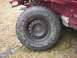 2001 Dodge 1500 - Close-up of a tire and wheel assembly attached to the frame of a vehicle.