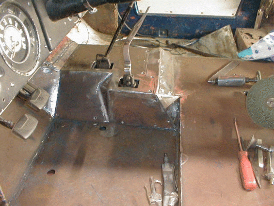 Close-up of rusted floor pan and metal components