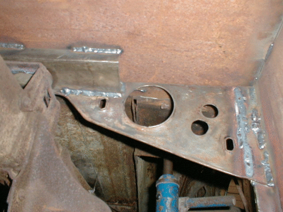 Underbody metal part with holes and brackets