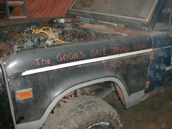 Dark vehicle fender and headlight, side view