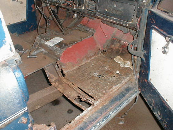 Vehicle floor with red seat components and metal framing