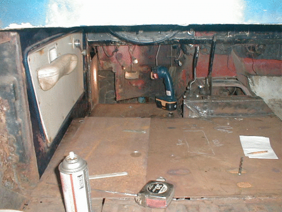 Vehicle interior with cardboard flooring and visible components