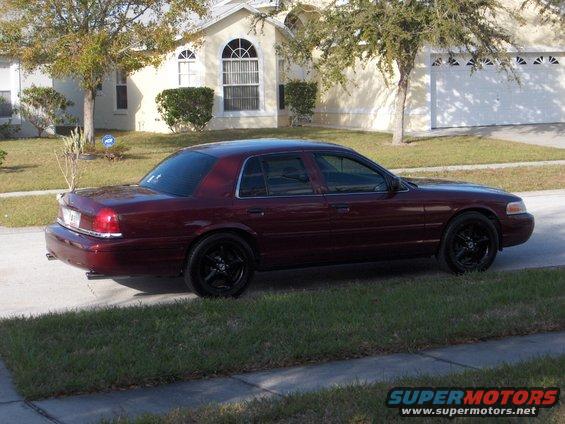 Maroon 2004 Ford Crown Victoria parked on a residential street