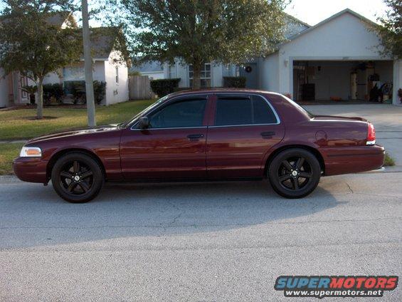Maroon 2004 Ford Crown Victoria sedan, side view, black rims