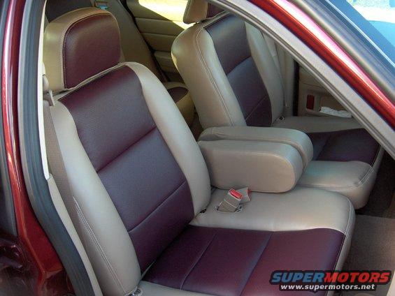 Interior shot of car seats with maroon and tan upholstery. Armrests are tan