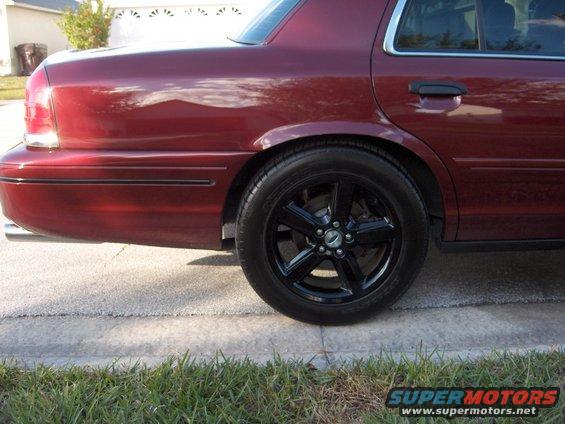 2004 Ford Crown Victoria rear quarter panel with black five-spoke wheel