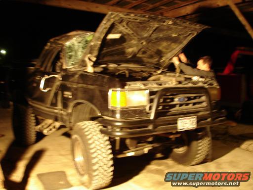 Black 1990 Ford Bronco with hood open, front grille visible