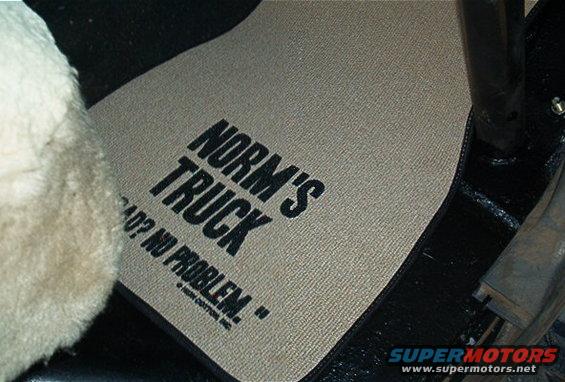 Tan floor mat with black text 'NORM'S TRUCK' and 'BAD? NO PROBLEM.'