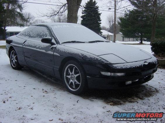Black 1995 Ford Probe in snow, 3q front view