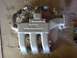 1995 Ford Probe - Intake manifold with V6 marking, likely from a car engine. Mounted on cardboard.