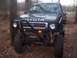 1995 Toyota Tacoma - A modified 1995 Toyota Tacoma is parked outdoors, showing its off-road tires and custom bumper.