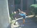 2003 Yamaha RAPTOR 80 - A young girl bends down to smell a rose in front of a closed gate.