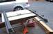 1979 Ford Bronco - Roof rack assembly is on jack stands next to a silver car and a red gas can.