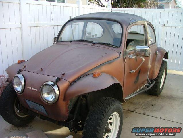 Brown Volkswagen Beetle dune buggy with off-road tires and roll cage