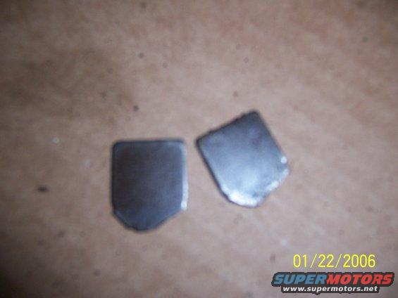 Two metal plates on a brown surface
