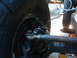 1994 Jeep YJ - Close-up view of the front wheel steering linkage on a 1994 Jeep YJ, showing the tie rod end and shock absorber.
