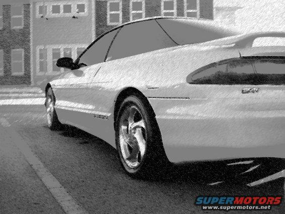 White sports coupe parked on street, buildings in background