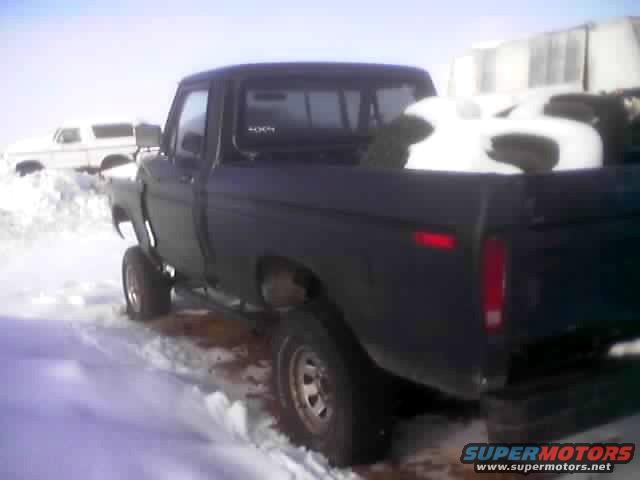 1979 Ford F-Series pickup truck in snow, another white SUV in background