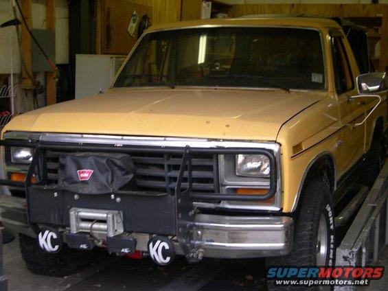 Yellow 1982 Ford Bronco front view with winch and KC lights